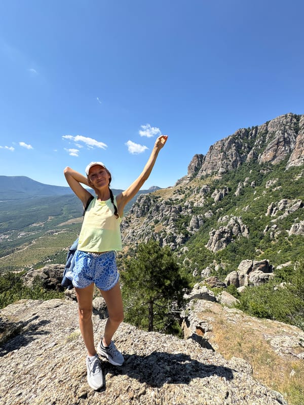 Hanging out on a cliff edge above a Ukrainian mountain valley