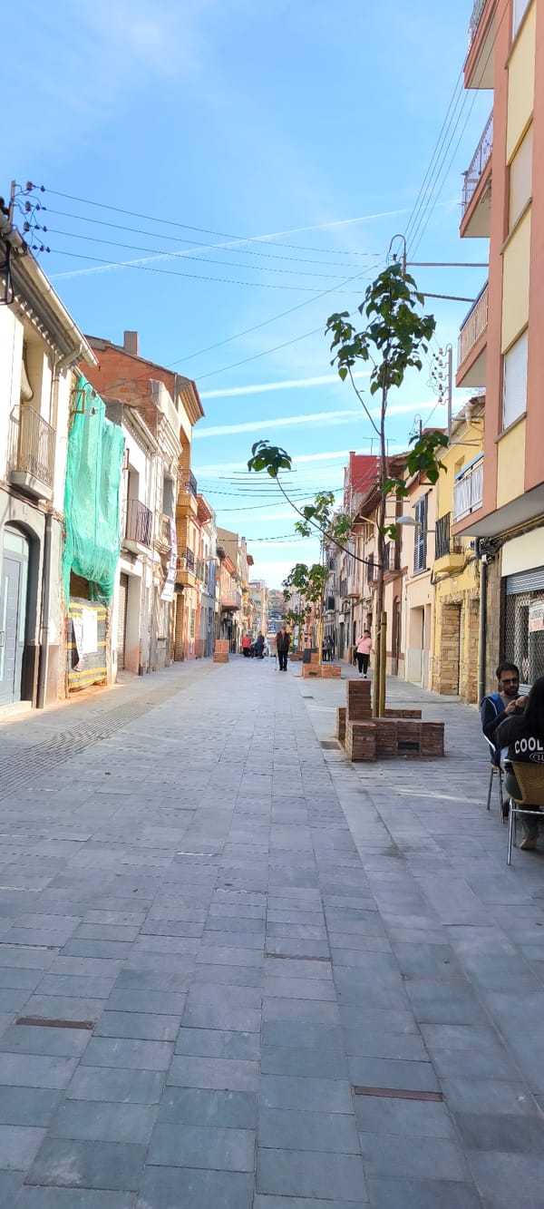 Morning street life and community gathering documented in Ripollet