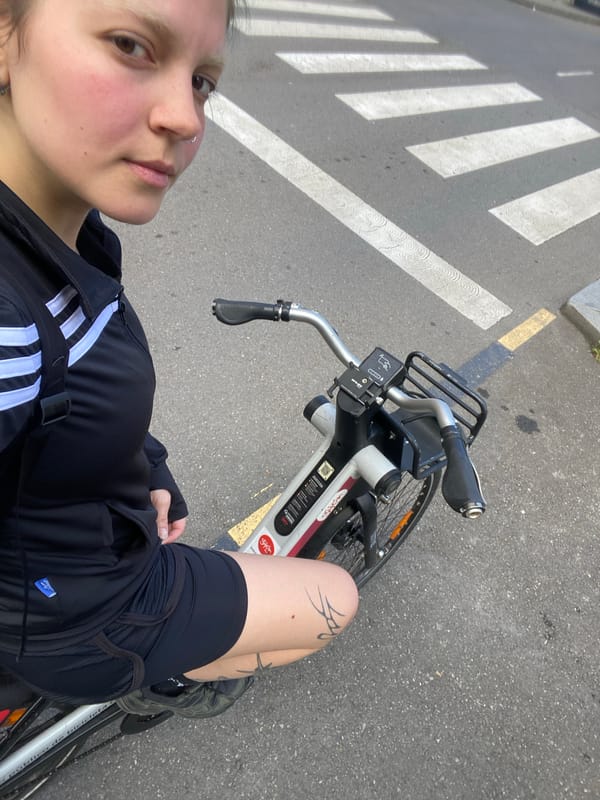 Woman photographs herself on public bike in Gijón