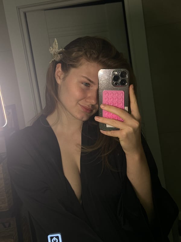 Person Takes Selfie With Pink Pop-It Phone Accessory
