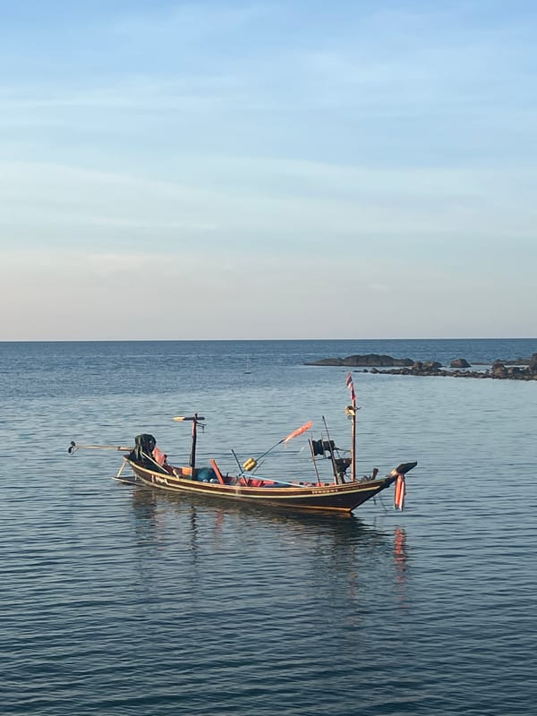 Golden hour along Ko Pha-ngan's coast, boats and calm water