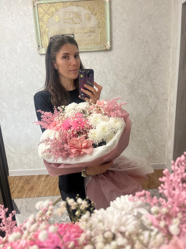 Woman captures flower bouquet selfies, quiet moments with child