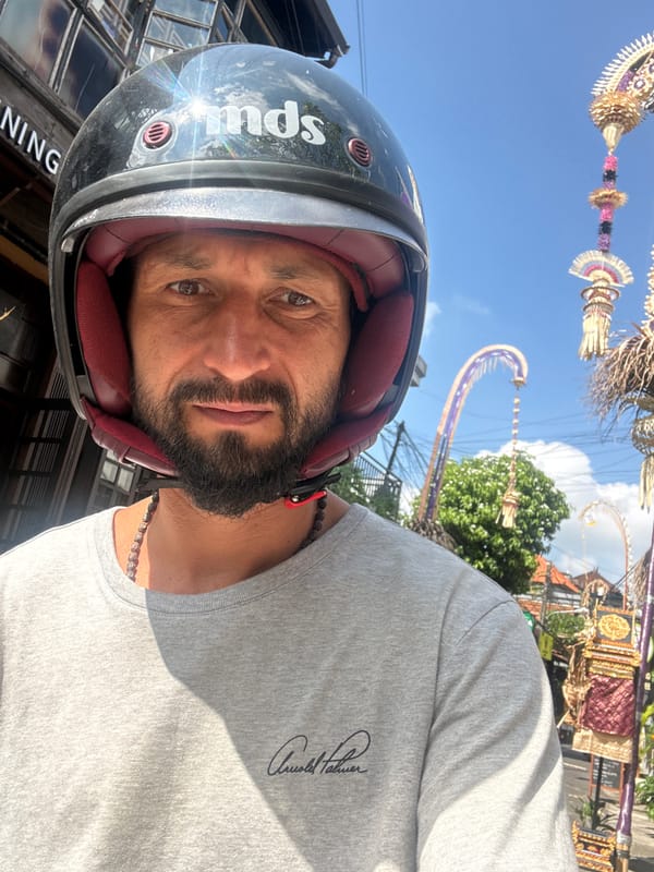 Helmeted rider and SUV on an Ubud road