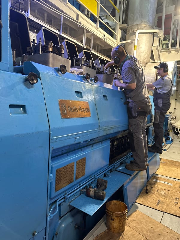 Workers service large industrial engine in Poti facility