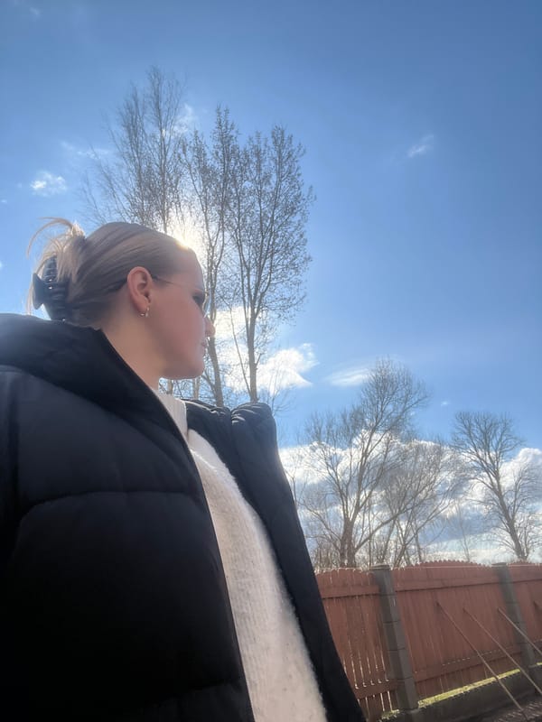 Portrait captured of blonde individual in black puffer jacket, Riga