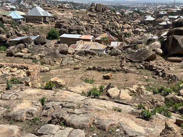 Rocky landscape with scattered buildings documented in Jos, Nigeria