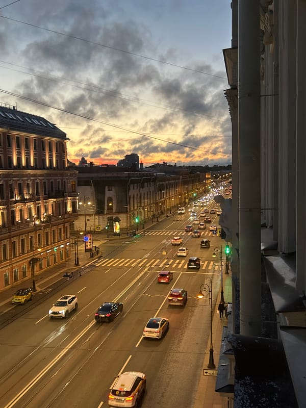 City street at dusk, sunset breaking through cloud cover
