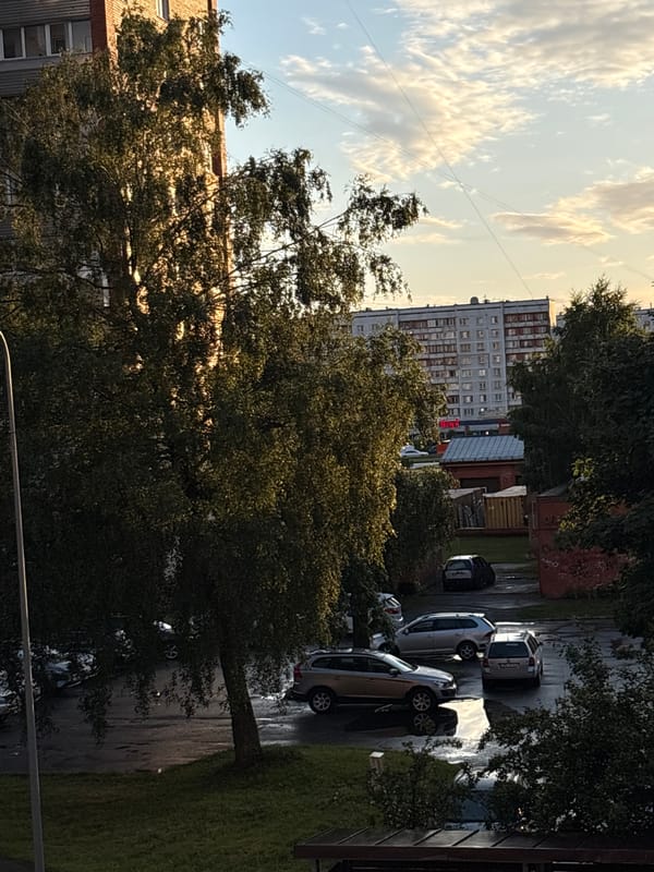 Summer evening light across a Riga residential neighborhood