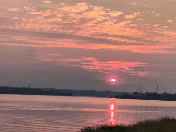 Quiet sunset over still water near Mencherep, Russia