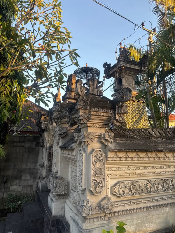 Dusk in Denpasar: temple walls, full moon, and market shelves