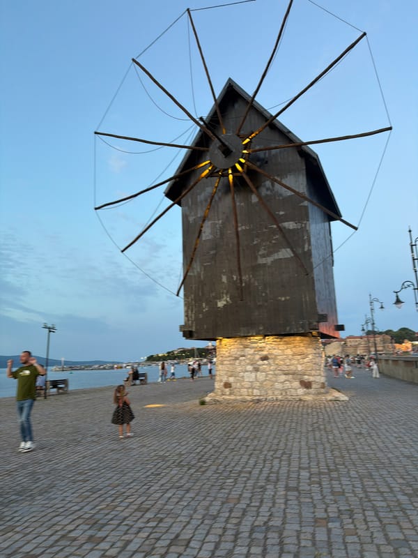 Nesebar's waterfront windmill at golden hour