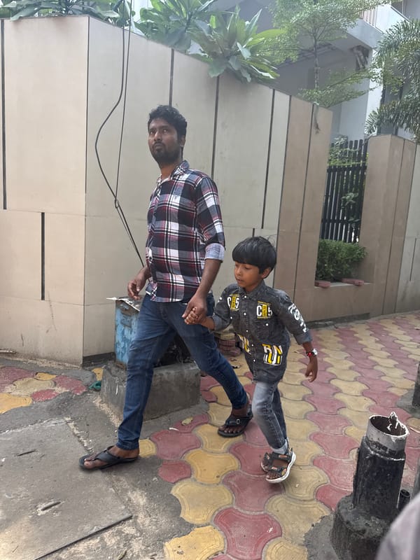 Adult and child photographed outside building in Kolkata