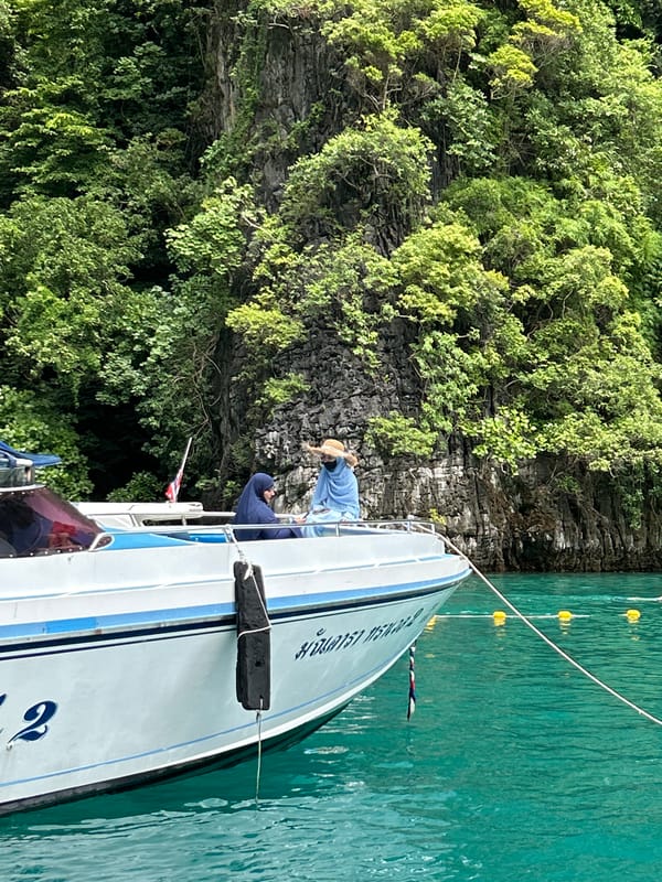 Swimming and boating at Haad Yao's cliffside waters