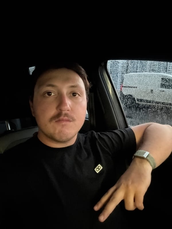 Man sits in vehicle during rain in Huixquilucan
