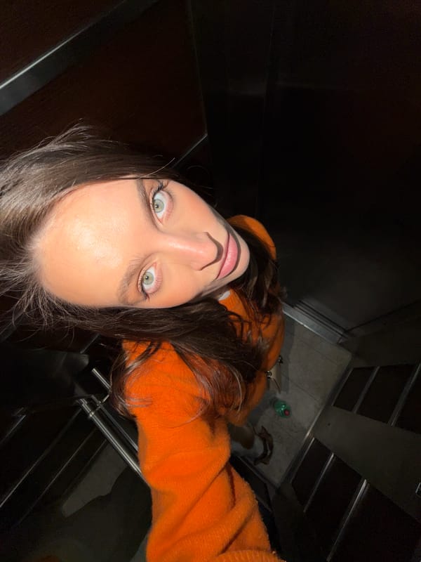 Woman takes selfies in elevator, walks through Budva parking garage