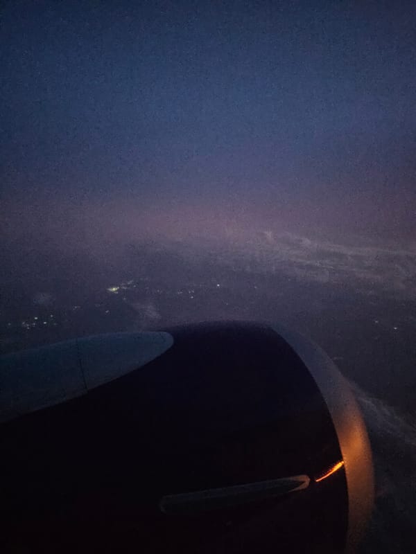 Airplane passenger documents nighttime flight over Turbo, Colombia