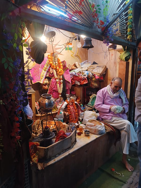 Delhi street life documented at midday Hindu shrine
