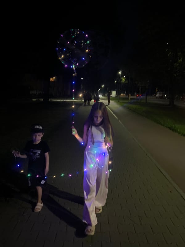 Kids with LED lights and bubbles on a night walk in Tychy