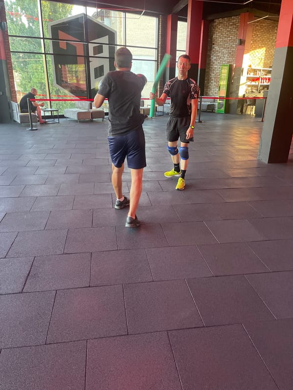 Pad work and sparring drills during a gym training session