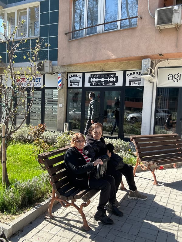 Two people sit on bench in Sofia Bulgaria