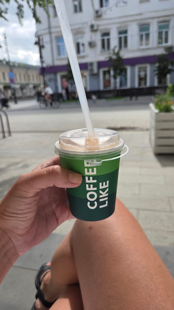 Street scenes, sculptures, and coffee on a busy urban block