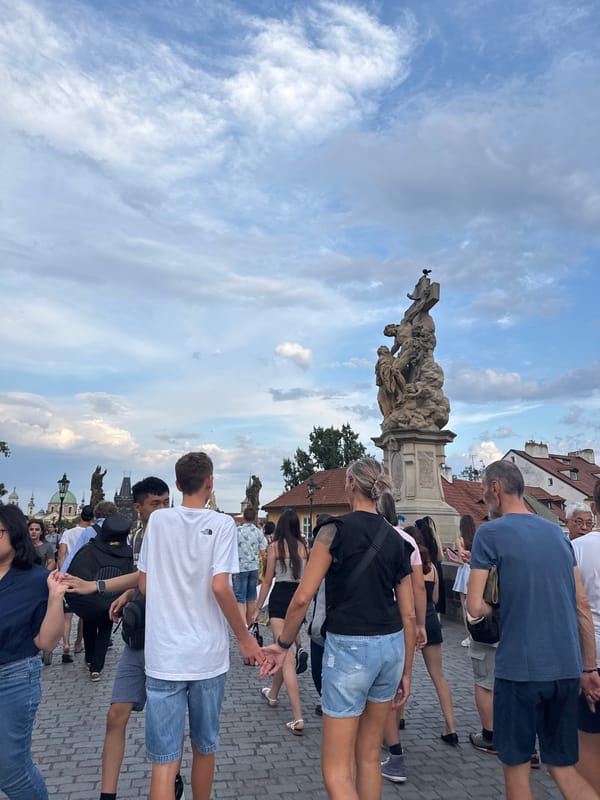 Charles Bridge crowds under dramatic summer skies, Prague