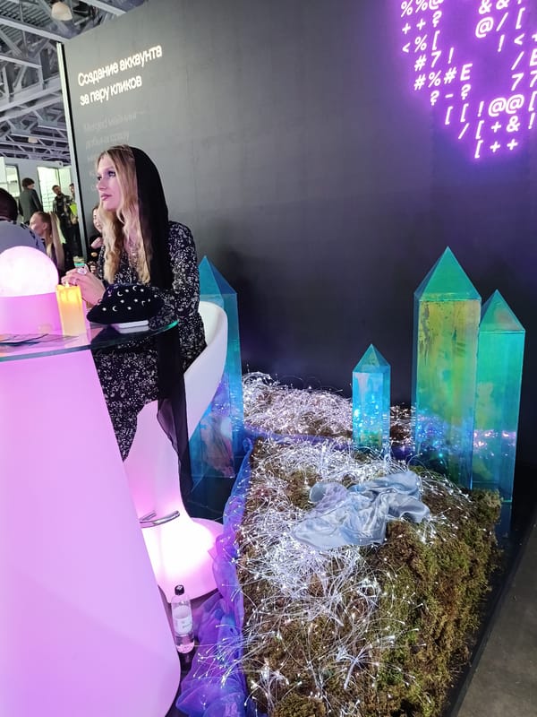 Woman in patterned dress observed at pink-lit table in Khimki