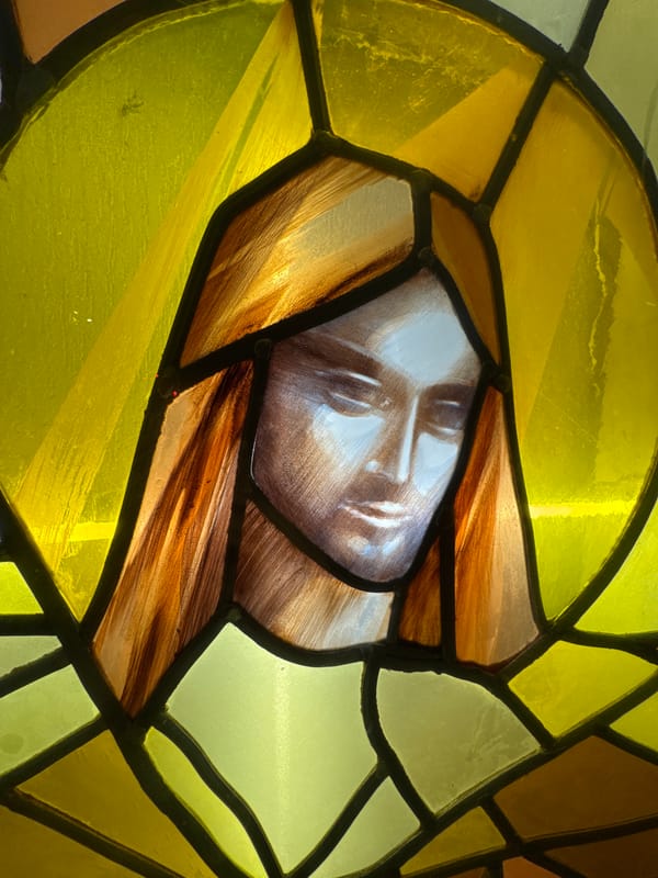 Stained glass religious figure with golden halo documented in Paris