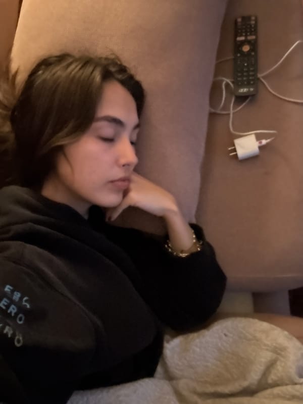Woman sleeps on couch in Mexico City early morning