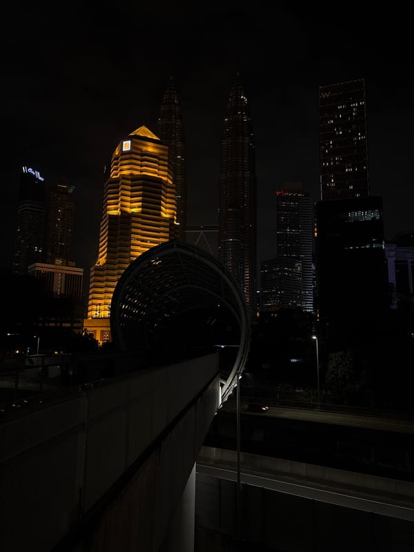 Evening skyline photography captures illuminated Kuala Lumpur landmarks