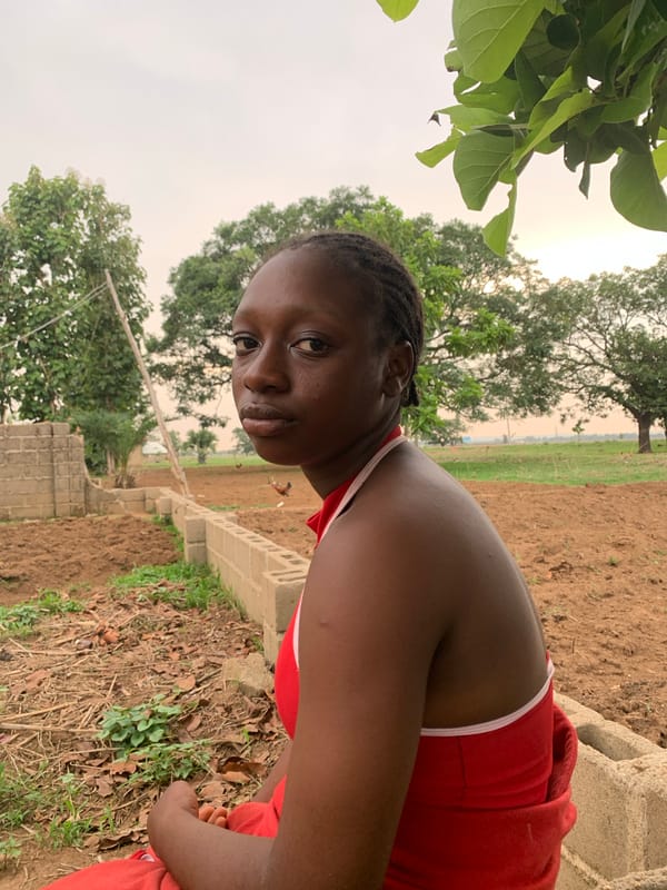 Woman in red tank top spotted across rural Nigeria locations