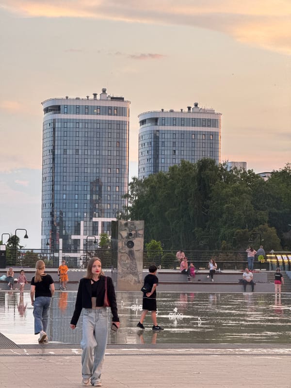 Evening fountain plaza scene with children playing in Izhevsk