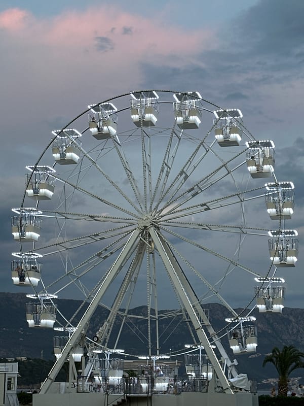 Illuminated Ferris wheel at dusk in Budva, Montenegro