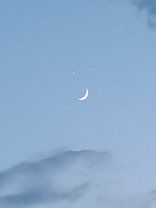 Crescent moon and planet at twilight over Vitoria-Gasteiz