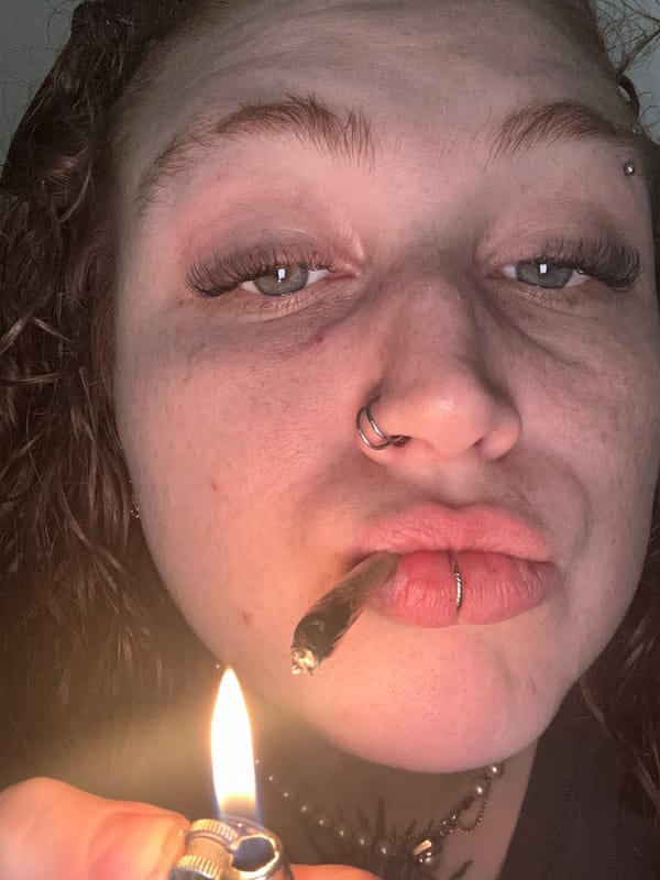Person with piercings smokes cigarette in Buenos Aires