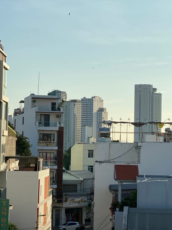 Street-level urban scenes with mountains, scooters, and overhead wires