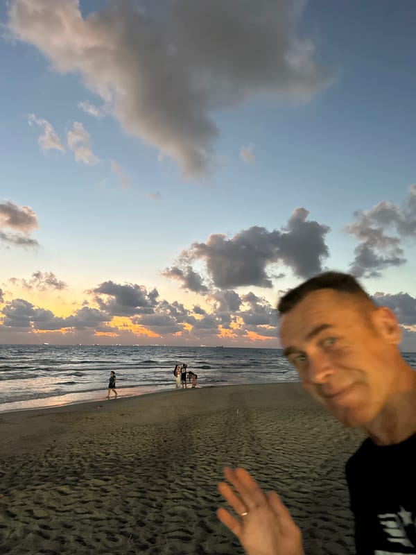 Kiryat Yam beachfront at dusk, ships and sunset clouds