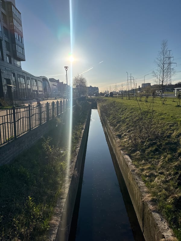 Sunlit water channel documented in Saint Petersburg urban landscape