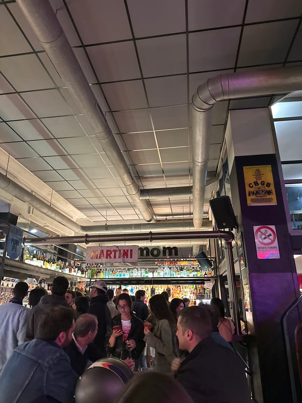 Crowded Milan bar features King Crimson artwork, packed patrons