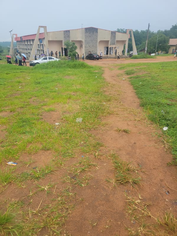 Morning activity around a Nigerian institutional campus with banks and ICT centre