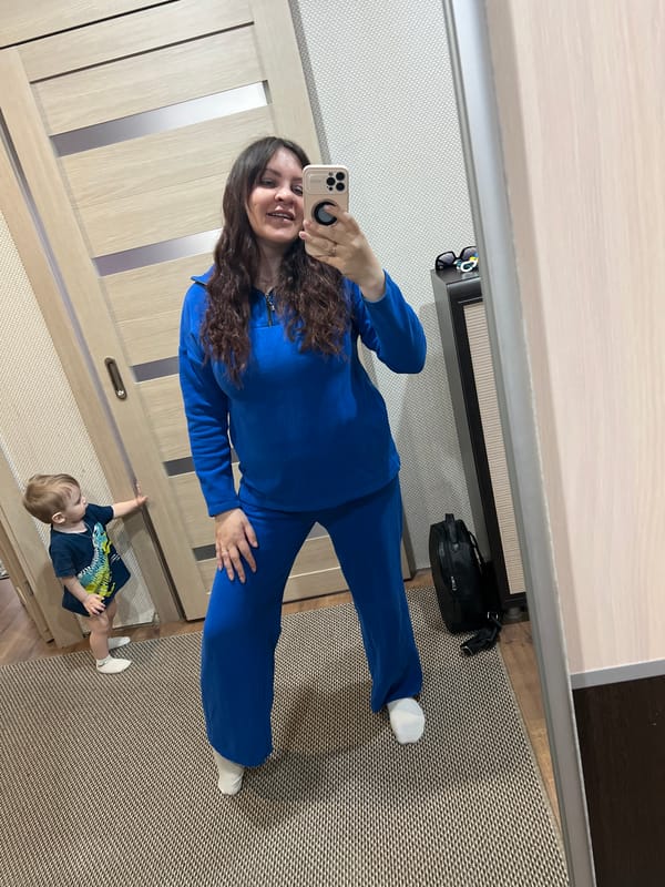 Woman holds alert dog near doorway in Noviy, Russia