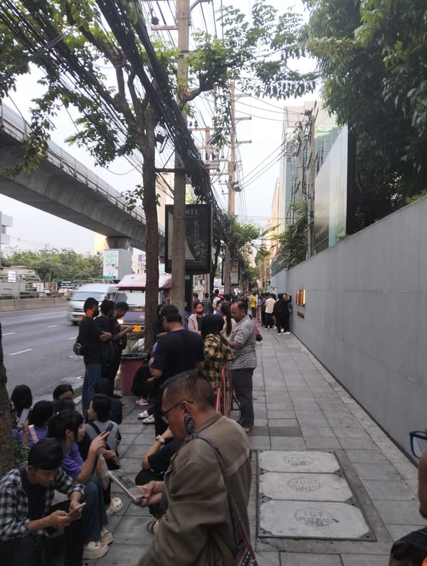 People queue outside Bangkok building late Thursday evening