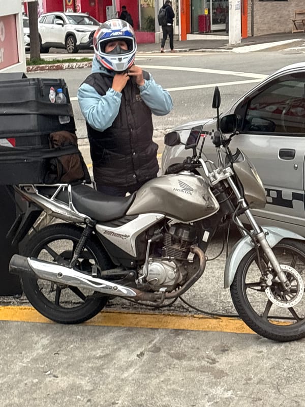 Street-level São Paulo: motorcycle, bus, and sidewalk life