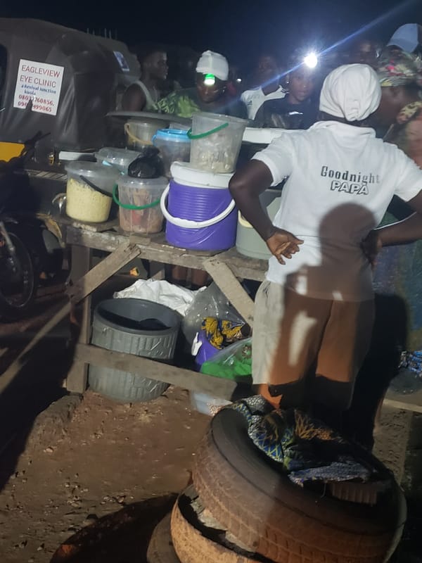 Night market food vendors serve customers in Ibadan