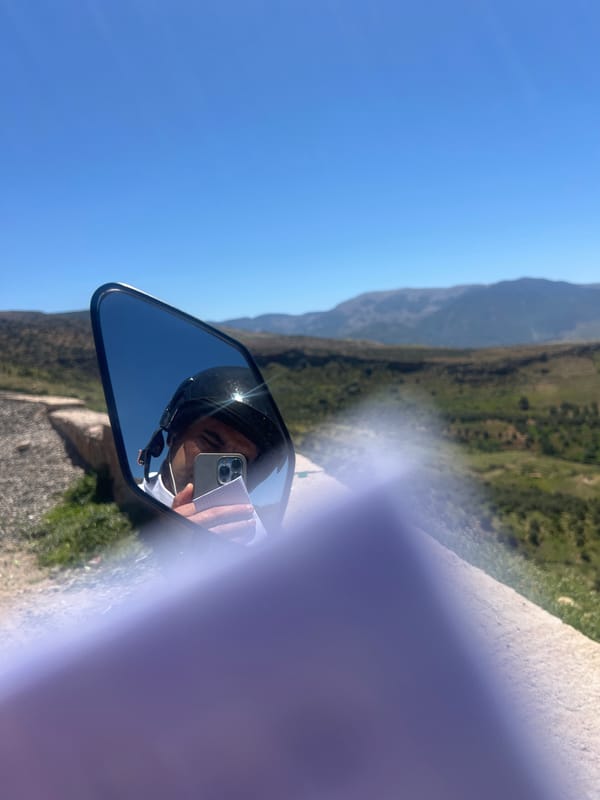 Motorcyclist captures selfie in mirror amid Morocco mountain landscape