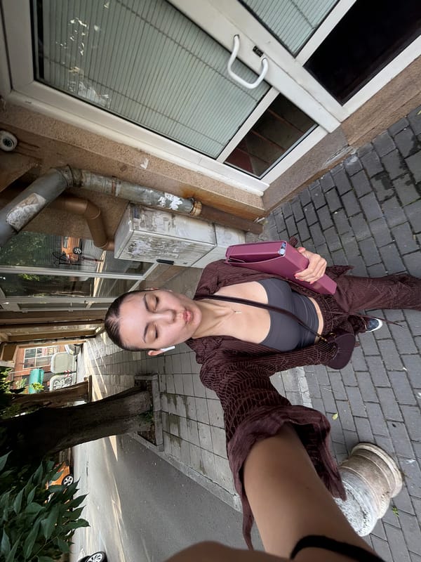 Woman takes morning selfies on sidewalk in Burgas, Bulgaria