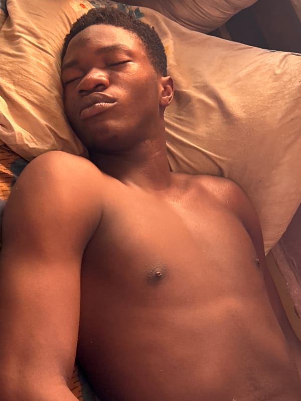 Young man resting indoors in Ihiagwa, Nigeria