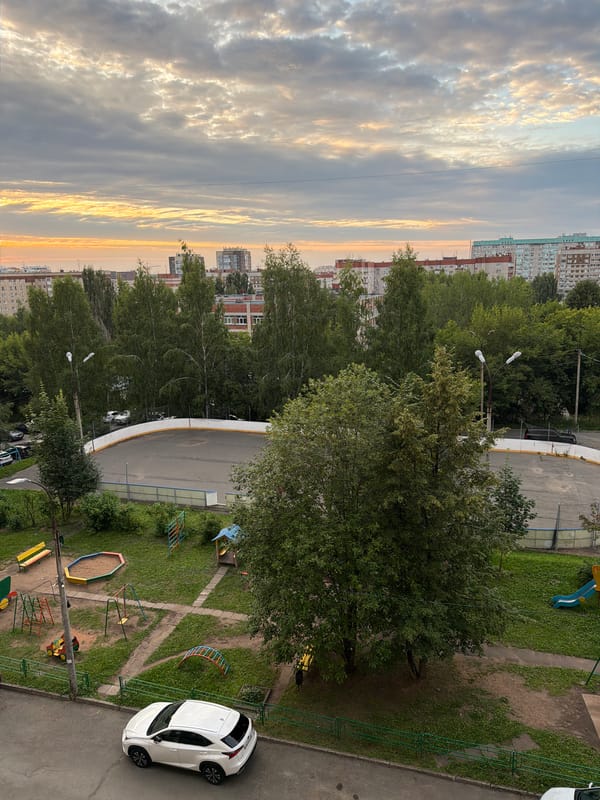 Soviet-era Izhevsk apartment blocks under a dramatic evening sky