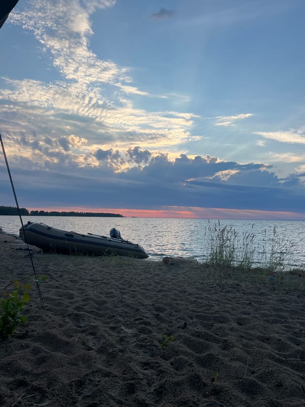 Inflatable boat on shore at dusk, Borovoe lakeside
