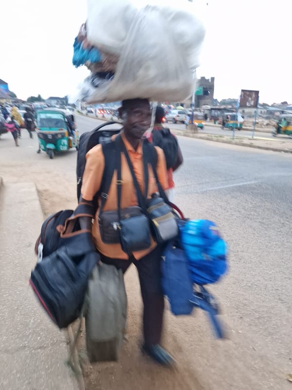 Foot traffic and daily life along a Jos street at dusk